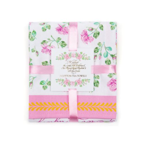 Folded rose tea towels wrapped in a pink ribbon