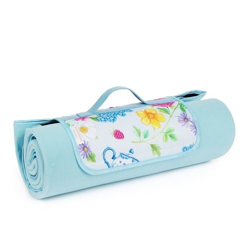 Rolled up blue picnic blanket printed with florals and other royal summertime symbols