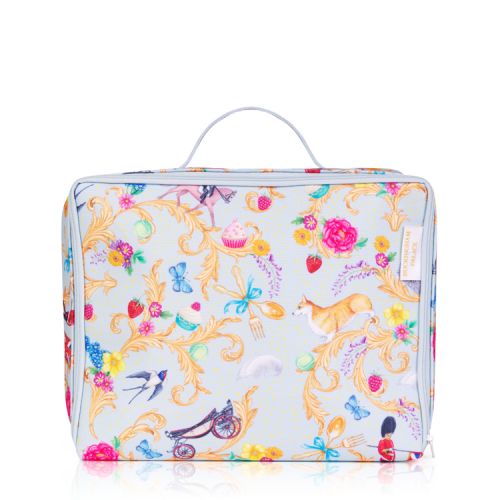 Blue sandwich bag patterned with florals and other emblems of a royal summertime including corgis, florals, strawberries, carriages and guardsman. There is a handle at the top and a blue zip runs around three edges.
