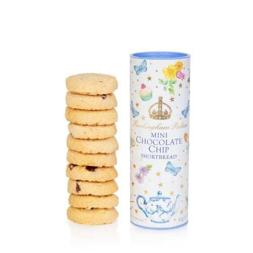 A pale blue cardboard tube of biscuits decorated with gold stars, colourful flowers, cakes, a floral teapot and butterflies. At the centre of the tube is a gold crown and 'Buckingham Palace' in gold. Underneath are the words 'Mini Chocolate Chip Shortbrea
