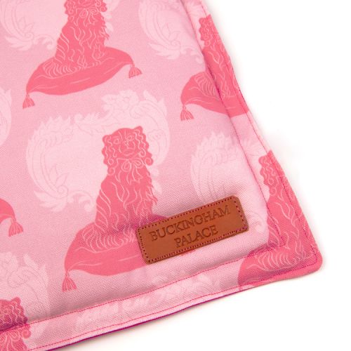 Square pet cushion printed with pink dog printed material with a leather tag saying Buckingham Palace