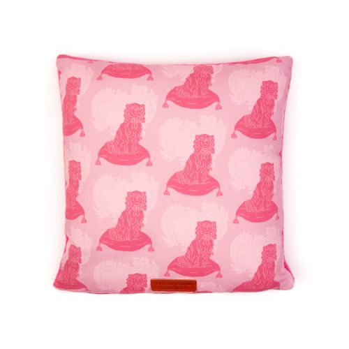 Square cushion made with material printed with pink dogs