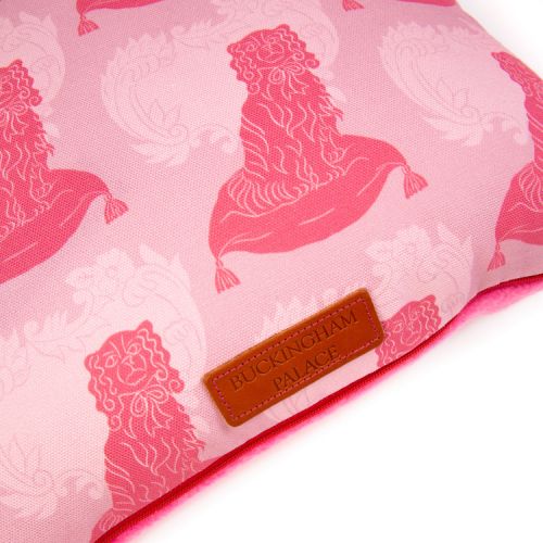 Square cushion made with material printed with pink dogs