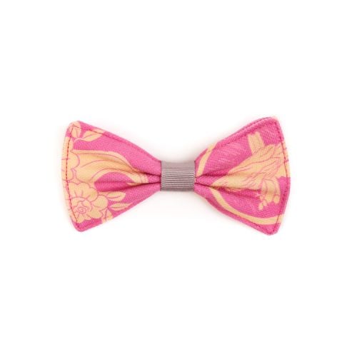 Pet bow tie made using pink material printed with yellow cats and parrots