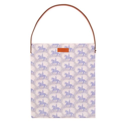 A tote bag printed with grey horses. It has a leather handle and a leather Buckingham Palace label