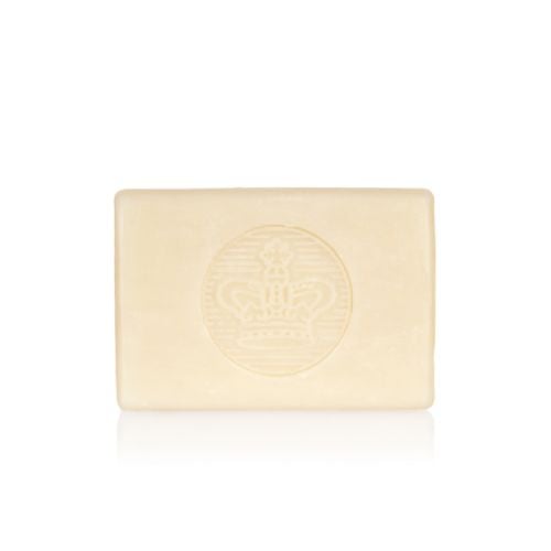 bar of soap wrapped in yellow paper printed with oranges and pears. There is also a gold seal with a crown and a white box saying 'Buckingham Palace Pear and Orange Blossom Premium English Soap Handmade in London'