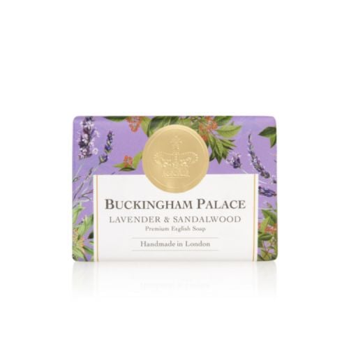bar of soap wrapped in purple paper printed with lavender and sandalwood plant. There is also a gold seal with a crown and a white box saying 'Buckingham Palace Lavender and Sandalwood Premium English Soap Handmade in London'