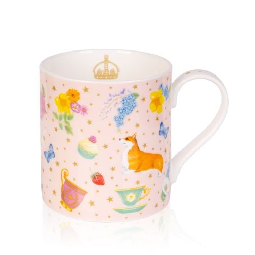 Pale pink mug decorated with corgis, yellow and blue florals, cakes, strawberries, butterflies and teacups. The pale pink background has gold stars and a gold coronet is printed on the inside of the mug.