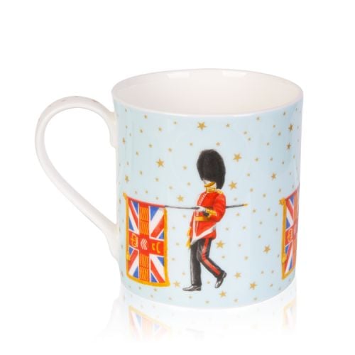 Pale blue mug decorated with guardsmen and flag. On the blue background are gold stars and on the inside of the mug is the gold coronet