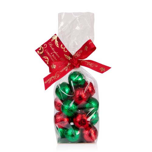Clear bag of red and green foiled truffles. The bag is tied with a red Buckingham Palace ribbon