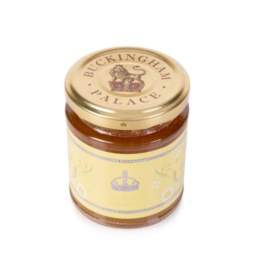 Jar of apricot and vanilla jam. Glass jar with gold lid and a yellow label featuring a crown and florals