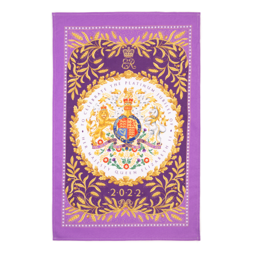 Rectangular, purple tea towel featuring the crest at the centre of the tea towel and surrounded by a gold foliage design.