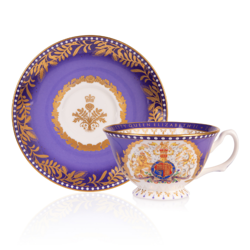 Purple teacup and saucer featuring a coat of arms and a gold foliage design