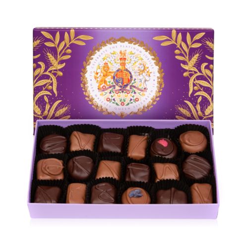 Purple open box of chocolates. On the lid a coat of arms features. The box contains plain and dark chocolates.