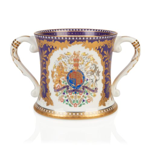 Platinum Jubilee Loving Cup. Purple and white with the Royal Coat of Arms for the United Kingdom in the centre. Finished with gold plating on the handles and base