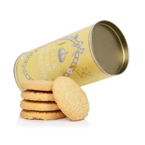 Yellow biscuit tube stood next to the pile of biscuits. The tube features a floral and crystal design.