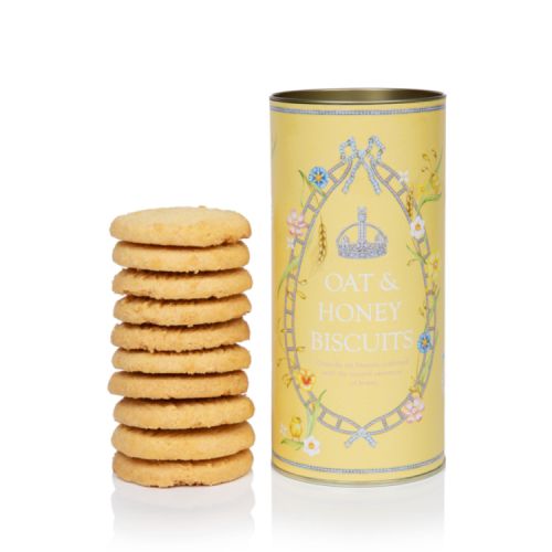 Yellow biscuit tube stood next to the pile of biscuits. The tube features a floral and crystal design.