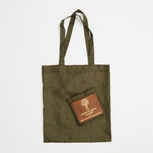 Green reusable shopping bag with green pouch and leather tag