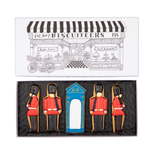 Box of iced biscuits shaped as guardsmen and a sentry box in a Biscuiteers illustrated box