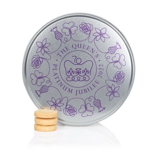 Silver round biscuit tin featuring a swirling purple line of flowers and The Queen's Platinum Jubilee Emblem next to a pile of three biscuits