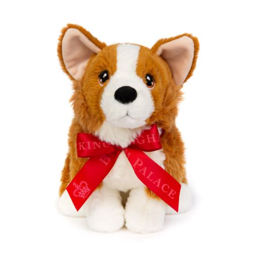 Seasons Greetings bag with Kings and Queens book, bag of chocolate coins and a soft toy corgi with red ribbon. Buckingham Palace written on both the corgi and the bag. 