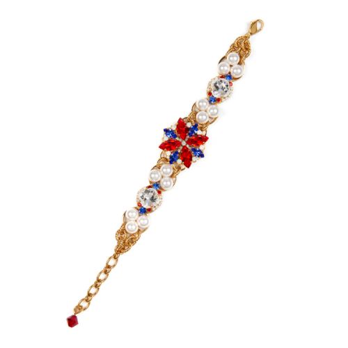 Statement gold bracelet with red and blue crystals in a star at the centre. 

The length of the bracelet is covered with trios of pearls, clear round crystals and small blue and red crystals. 

Chain fasten. 