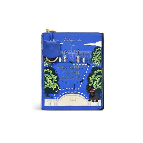 Blue cross body bag featuring an illustration of Buckingham Palace façade, trees and the Radley black Scottie dog. The words 'Piccadilly To The Palace' feature at the centre 