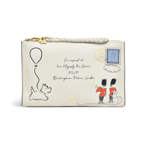 White coin purse featuring the words 'On request of Her Majesty The Queen RSVP Buckingham Palace London.' There are also two guards and a corgi with a balloon. There is a stamp in the top right corner.