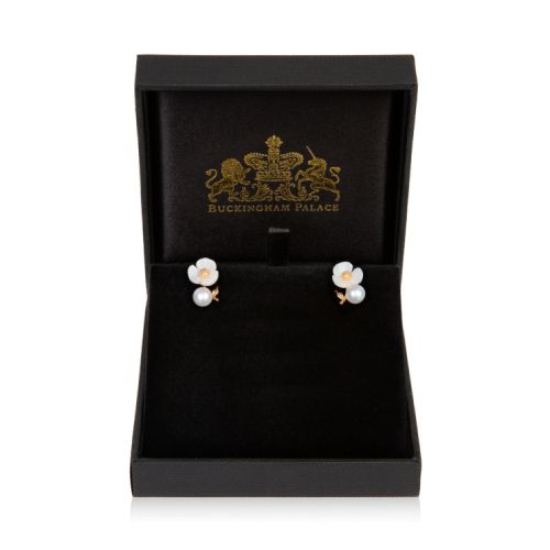 White flower earrings with pearl attached to gold stem.
