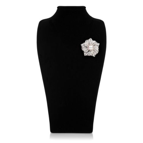 Silver lower brooch made with glass crystal and a costume pearl at the centre.
