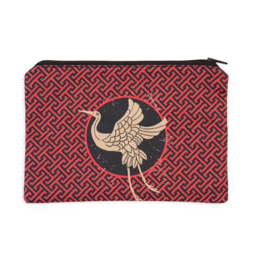 Zip pouch with printed pattern in red, black and brown.