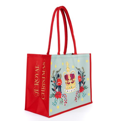 bag with decorative christmas illustrations surrounded by contents of the bag including festive treats to eat and tea towel