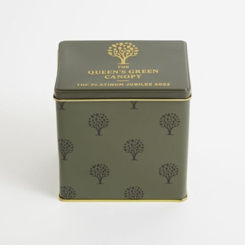 Green cube tin printed with trees and the words 'The Queen's Green Canopy The Platinum Jubilee 2022' in gold