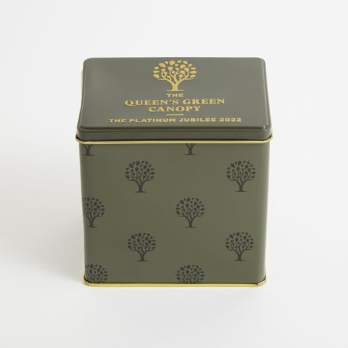 Green cube tin printed with trees and the words 'The Queen's Green Canopy The Platinum Jubilee 2022' in gold