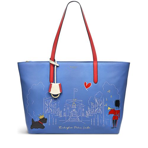 Front of blue tote bag. With red handles and swing tag. Illustration of Buckingham Palace and applique Scottie dog and Guardsman.