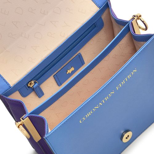 Radley book bag with crown and specter on the spine. Front of bag features a sketch of Buckingham Palace, guardsmen and the Radley Scottie dog wearing Coronation robes. 