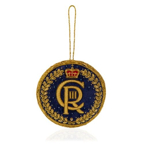 Navy round decoration with gold embroidery of CIIIR and a crown. 