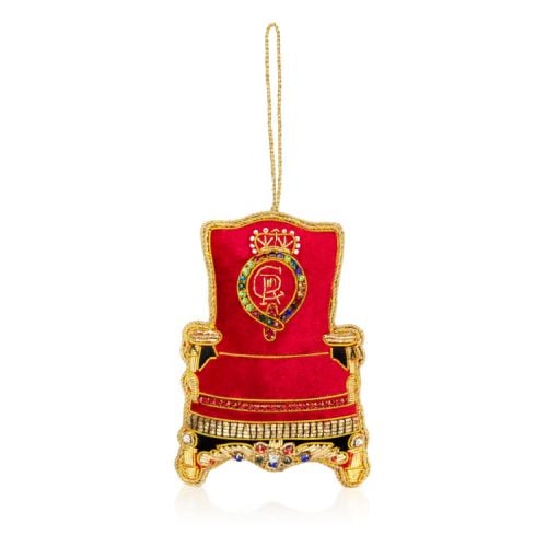 Red throne decoration finished with gold thread. At the centre of the chair is King Charles III cypher. 