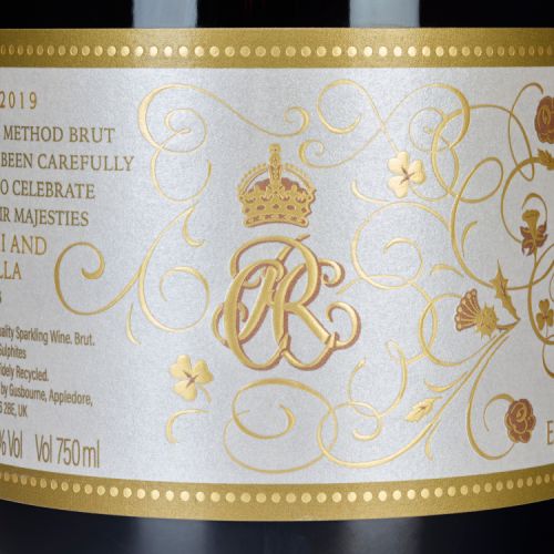 Gusbourne English Sprakling wine. Royal coat of arms in gold on white label.