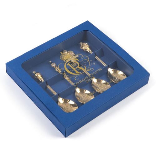 4 gold spoons with commemorative toppers. Presented in a blue box with perspex window