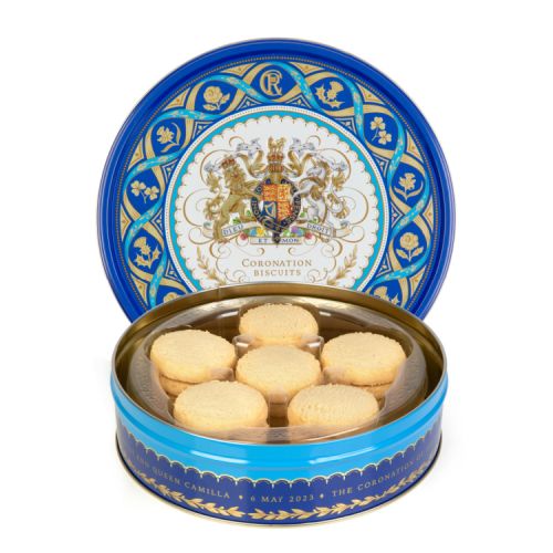 Blue round biscuit tin featuring the Royal coat of arms at the centre of the tin including the lion and the unicorn. Surrounding the coat of arms is a border of golden daffodils, roses, shamrocks and thistles. The tin is open to show the shortbreads insid