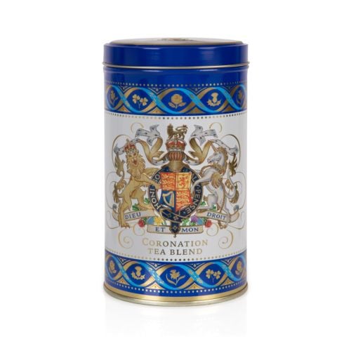 Blue and white tea caddy featuring the Royal Coat of Arms. The crest is framed with a border of thistles, roses, shamrocks and daffodils.