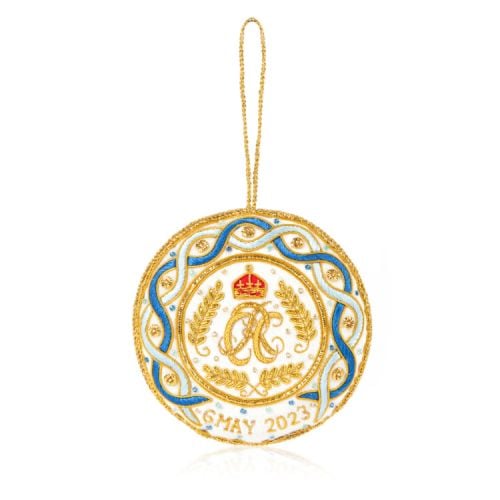 White decoration with blue and gold stitching. Joint cypher of their majesties at the centre and the date of the coronation at the bottom.