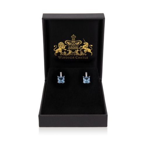 earrings with light blue gems and small silver gem details above.