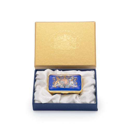 Lid of pill box. Blue with gold edges and the Royal coat of arms at the centre.