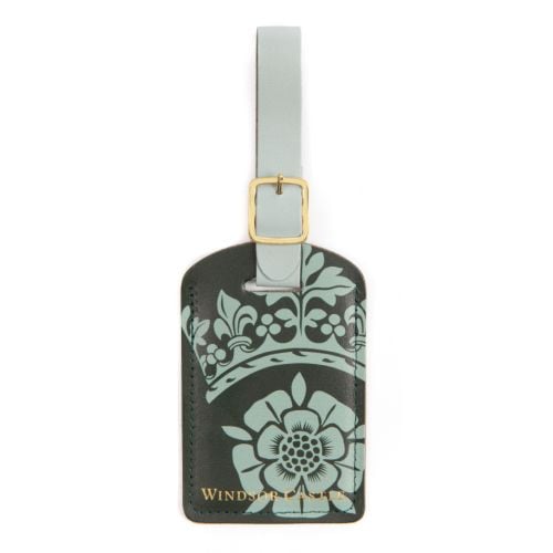 Green luggage tag with gold detailing on buckle strap. Windsor Castle wording in gold foil and windsor crest illustration.