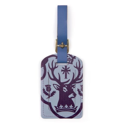 luggage tag in blue and purple, a crest of a stag and thistle illustrations and the wording palace of holyroodhouse in gold foil
