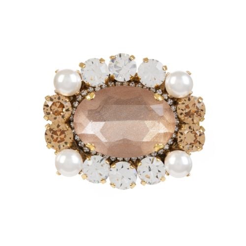 Pink oval crystal surrounded by orange and clear crystals and four costume pearls. 