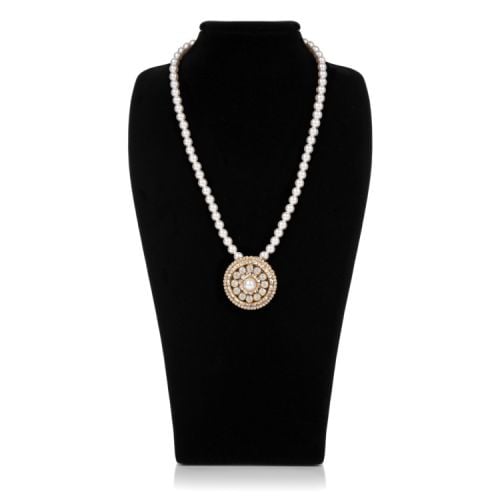 Single strand pearl necklace with gold fasten. Circular pendant with pearls and crystal detail