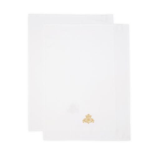 Two white tea towels overlapping with gold embroidered crest central at the bottom.